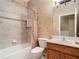 Clean bathroom with tile shower, toilet and wood vanity at 5255 Athens Way, Venice, FL 34293