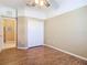 Bright bedroom with wood-look tile floors and double door closet at 5255 Athens Way, Venice, FL 34293