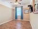 Spacious bedroom with wood-look tile floors and ceiling fan at 5255 Athens Way, Venice, FL 34293