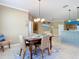 Dining area with a rustic table and wicker chairs at 5255 Athens Way, Venice, FL 34293