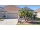 Charming villa with 2-car garage, attractive landscaping, and welcoming front porch at 5255 Athens Way, Venice, FL 34293