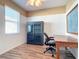 Bright home office features built-in shelving and hardwood floors at 5255 Athens Way, Venice, FL 34293