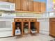 Oak kitchen cabinets with pull-out drawers and white appliances at 5255 Athens Way, Venice, FL 34293