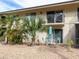 Backyard patio area with palm trees, shrubs, and a dining set at 533 Parkdale Mews # 533, Venice, FL 34285