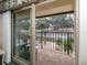 Balcony with sliding glass doors, offering views of lush greenery and trees at 533 Parkdale Mews # 533, Venice, FL 34285