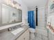 Bathroom featuring a bathtub, white vanity, and gray tile shower walls at 533 Parkdale Mews # 533, Venice, FL 34285