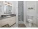 Clean bathroom with granite countertop, shower, and toilet at 533 Parkdale Mews # 533, Venice, FL 34285