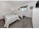 Bedroom with two twin beds, white furniture, and wood-look flooring at 533 Parkdale Mews # 533, Venice, FL 34285
