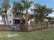 Front exterior view of Parkdale Mews condo building with tropical landscaping and signage at 533 Parkdale Mews # 533, Venice, FL 34285