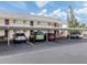 Covered parking area with several vehicles parked beneath it at 533 Parkdale Mews # 533, Venice, FL 34285