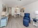 Dining area with a white table and chairs and coastal-themed artwork at 533 Parkdale Mews # 533, Venice, FL 34285
