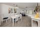 Dining area open to the living room with sliding glass doors to balcony at 533 Parkdale Mews # 533, Venice, FL 34285
