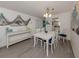 Dining room with coastal decor, white table, and view of the kitchen at 533 Parkdale Mews # 533, Venice, FL 34285