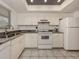 Kitchen featuring white cabinets, granite counters, and stainless steel sink at 533 Parkdale Mews # 533, Venice, FL 34285