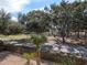 View from a balcony of a community park with trees, path, and wooden fence at 533 Parkdale Mews # 533, Venice, FL 34285