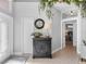 Inviting entryway with decorative console table and large clock at 535 Westmount Ln, Venice, FL 34293