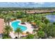 Aerial view of pool and lounge area with trees and residences, offering a private retreat at 5584 Cantucci St, Nokomis, FL 34275