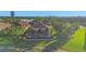 Aerial view of a beautiful home with a screened pool enclosure and lush landscaping on a waterfront lot at 5584 Cantucci St, Nokomis, FL 34275