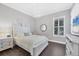 Bedroom with white furniture, dark wood floors, a chandelier, and natural light at 5584 Cantucci St, Nokomis, FL 34275