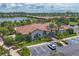 Overhead view of the clubhouse offering parking, manicured landscaping and beautiful water view beyond the homes at 5584 Cantucci St, Nokomis, FL 34275