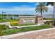 Beautiful Bellacina by Casey Key community sign surrounded by lush landscaping with blue skies in the background at 5584 Cantucci St, Nokomis, FL 34275