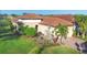 Charming single-story home with well-manicured landscaping, a tiled roof, and an inviting front entrance at 5584 Cantucci St, Nokomis, FL 34275
