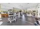 Bright fitness center with modern equipment, mirrors, ceiling fans, and large windows at 5584 Cantucci St, Nokomis, FL 34275