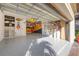 Spacious garage featuring an epoxy floor, built-in shelving, and organized storage for tools and accessories at 5584 Cantucci St, Nokomis, FL 34275