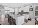 Modern kitchen with a center island, stainless steel appliances, and white cabinetry, providing a clean, stylish look at 5584 Cantucci St, Nokomis, FL 34275