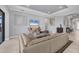 Bright living room with modern decor, a comfortable sofa, and ample natural light flowing through the large windows at 5584 Cantucci St, Nokomis, FL 34275