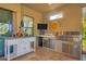 Well-equipped outdoor kitchen featuring a built-in grill, sink, refrigerator, TV, and countertop space at 5584 Cantucci St, Nokomis, FL 34275