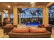 Covered outdoor patio featuring wicker furniture, a view of the pool, and a screened enclosure at 5584 Cantucci St, Nokomis, FL 34275
