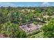 Community playground with slides, see-saws and climbing equipment surrounded by lush greenery and palm trees at 5584 Cantucci St, Nokomis, FL 34275