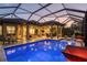 Sparkling pool with sun loungers and a screened enclosure, perfect for outdoor relaxation and entertainment at 5584 Cantucci St, Nokomis, FL 34275