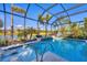 Inviting pool area within a screened enclosure offering views of the lake and surrounding landscape at 5584 Cantucci St, Nokomis, FL 34275
