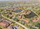 Aerial view of condo community near water, showing a desirable location at 5635 Golf Pointe Dr # 105, Sarasota, FL 34243