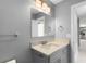 Modern bathroom with gray vanity, quartz countertop and a mirror at 5744 Kenwood Dr, North Port, FL 34287