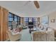 Bright living room featuring ocean views and comfortable seating at 629 Alhambra Rd # 704, Venice, FL 34285