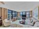 Spacious living room with ocean views, comfortable seating, and large windows at 629 Alhambra Rd # 704, Venice, FL 34285