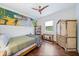 Bedroom with wooden furniture, unique wall art, and wood flooring at 676 Eagle Watch Ln, Osprey, FL 34229