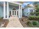 Front entry with double doors, columns, and a tiled walkway at 676 Eagle Watch Ln, Osprey, FL 34229