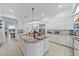 Stylish white kitchen with granite countertops, an island, and stainless steel appliances at 676 Eagle Watch Ln, Osprey, FL 34229