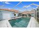 Inviting in-ground pool with a screen enclosure at 676 Eagle Watch Ln, Osprey, FL 34229