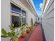 Landscaped side yard with brick pathway and cacti at 6906 Curtiss Ave # 132, Sarasota, FL 34231