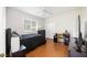 Neat bedroom with ceiling fan, closet, desk and hardwood floors at 6930 Treymore Ct, Sarasota, FL 34243