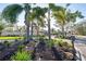 Gated community entrance with lush landscaping and palm trees, providing a secure and tropical welcome at 6930 Treymore Ct, Sarasota, FL 34243