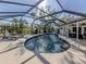 Sparkling kidney-shaped pool with screened enclosure and lounge chairs at 7173 Antigua Pl, Sarasota, FL 34231