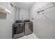 Laundry room with washer, dryer, and shelving at 7727 36Th E Ln, Sarasota, FL 34243