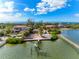 Picturesque aerial view of a waterfront home with a dock on a tranquil canal at 7825 Manasota Key Rd, Englewood, FL 34223