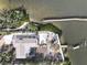 An aerial view captures the expansive layout and waterfront location of this home at 7825 Manasota Key Rd, Englewood, FL 34223